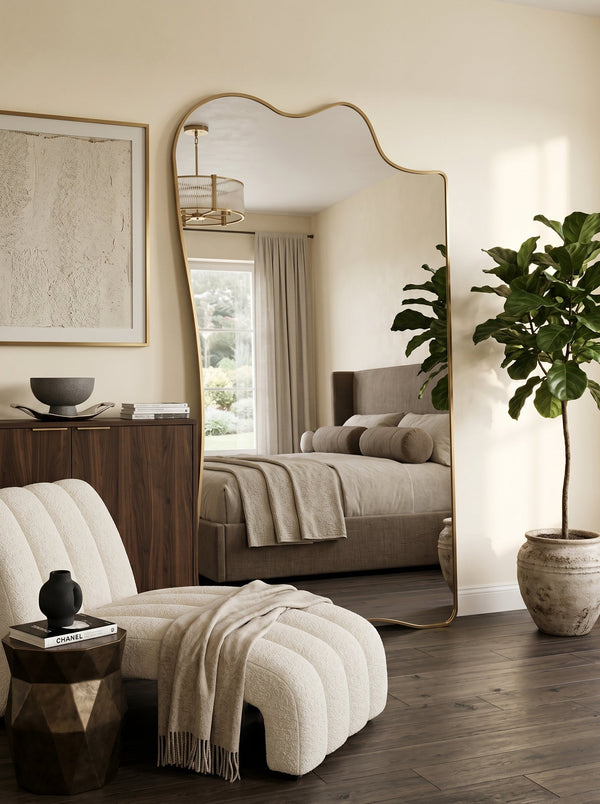Champagne gold full-length asymmetrical leaner mirror in a neutral bedroom with a fiddle-leaf fig
