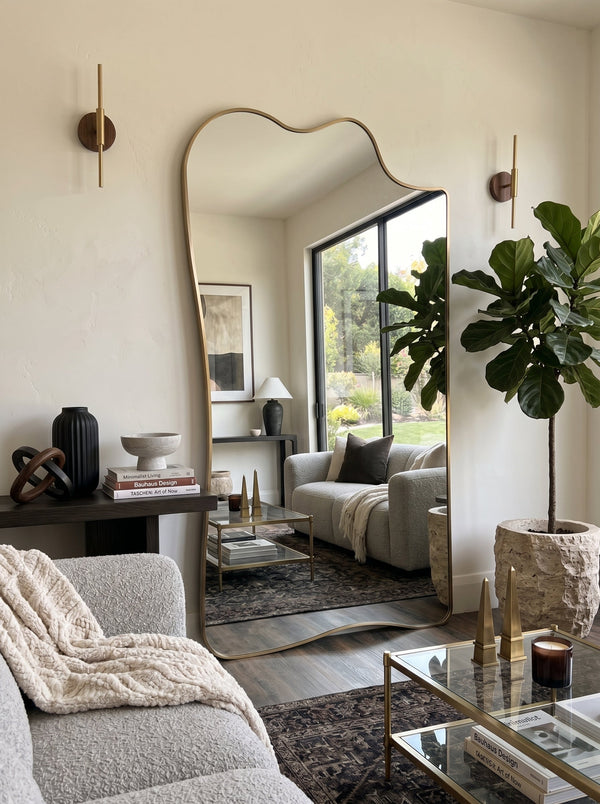 Champagne gold full-length asymmetrical leaner mirror in a bright living room